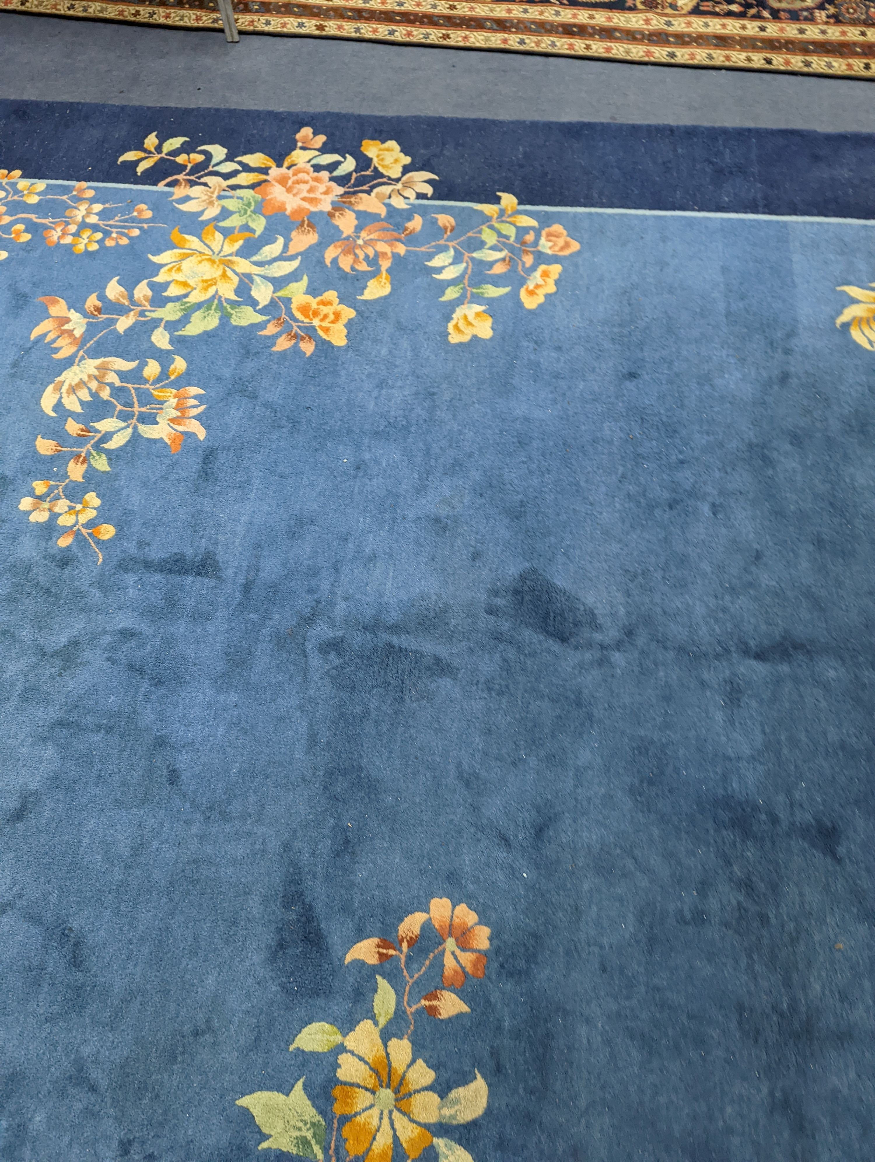 An early 20th century Art Deco Chinese blue ground floral carpet, 400 x 310cm